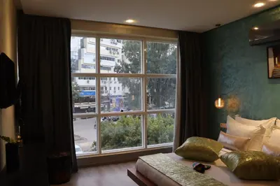 a bedroom with a large window and a bed and a couch at Luxury Appartement Noor in Fès
