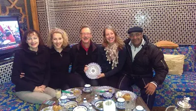 a group of people posing for a picture in a room at Riad Les Chrifis Navette Aéroport 24 sur 24 in Fès