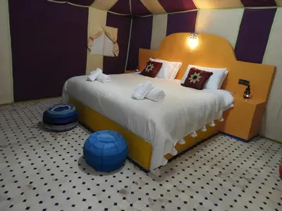 a bedroom with a bed in a lego room at Sleep In Luxury Tent In Desert in Merzouga
