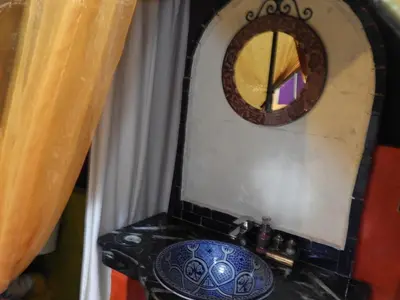 a bathroom with a sink and a mirror at Sleep In Luxury Tent In Desert in Merzouga