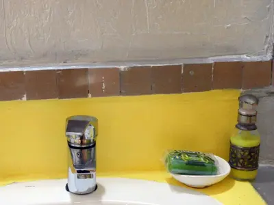 a kitchen counter with a sink with a bottle and apotion at Sleep In Luxury Tent In Desert in Merzouga