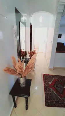 a room with a vase with a plant on a table at Welcome Home in Beni Mellal