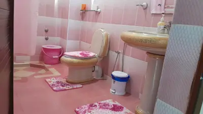 a pink bathroom with a toilet and a sink at Welcome Home in Beni Mellal