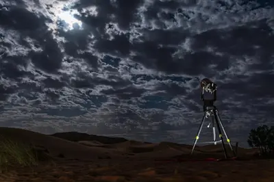 a camera on a tripod in the desert at Paradis Du Sahara in Merzouga