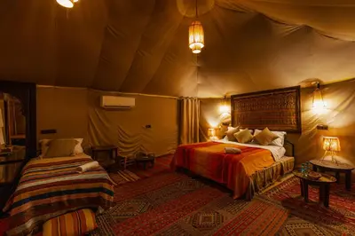 a bedroom with two beds in a tent at Paradis Du Sahara in Merzouga