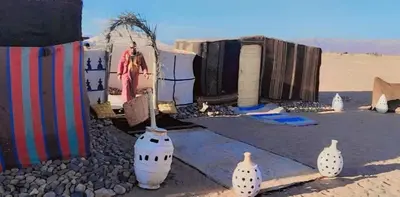 a group of vases sitting in the desert at Tikida Camp by tinfou in Zagora
