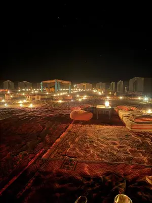 a view of a city at night with many beds at Chigaga Desert Camp in Mhamid