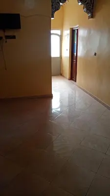 an empty room with a tile floor and a door at Chez zakaria guest house in Merzouga
