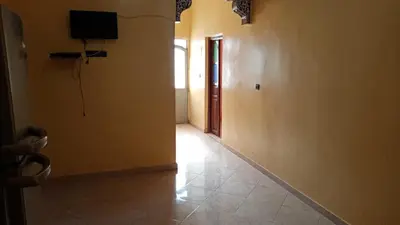 a hallway with a door and a television on the wall at Chez zakaria guest house in Merzouga