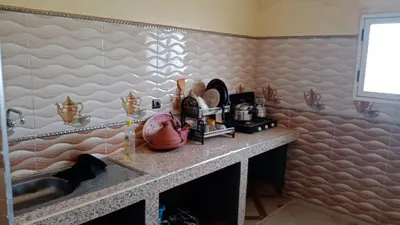 a kitchen with a counter with a sink and a counter at Chez zakaria guest house in Merzouga