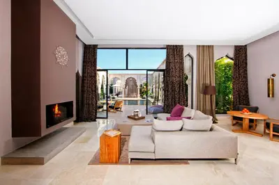 a living room with a couch and a fireplace at Palais Namaskar in Marrakech
