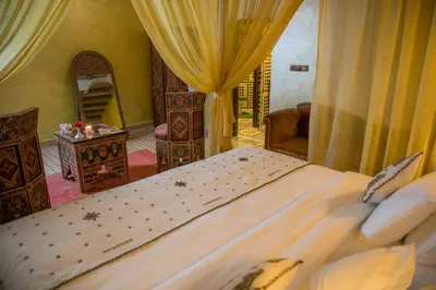 a bedroom with a large bed in a room at Ksar Elkabbaba Kasbah & SPA in Skoura