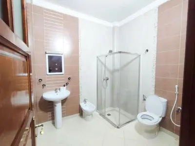 a bathroom with a shower and a toilet and a sink at SkyRise 1 Khemisset 2 bedrooms in Khemisset