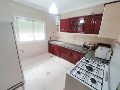 a small kitchen with a stove and a sink at SkyRise 1 Khemisset 2 bedrooms in Khemisset