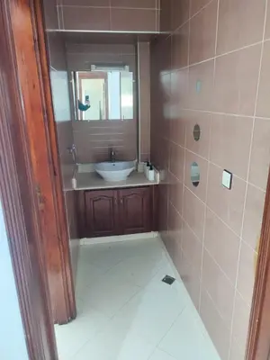 a bathroom with a sink and a mirror at SkyRise 1 Khemisset 2 bedrooms in Khemisset