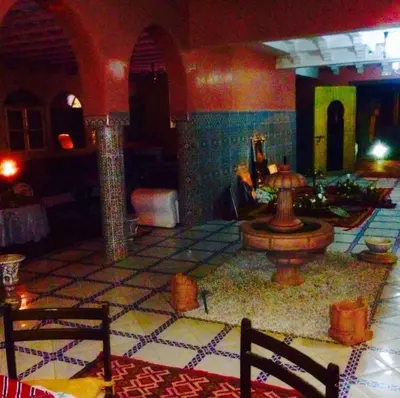 a room with a fountain in the middle of a room at riad lala fatima in Ouzoud