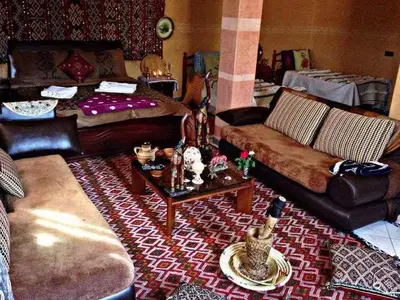 a living room with a couch and a table at riad lala fatima in Ouzoud