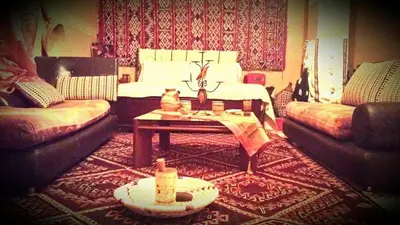 a living room with a couch and a coffee table at riad lala fatima in Ouzoud