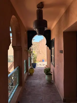 an alley way with potted plants in a building at Riad Kasbah Omar in Ourika
