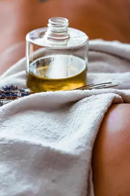 a glass jar of oil on top of a towel at Riad Kasbah Omar in Ourika
