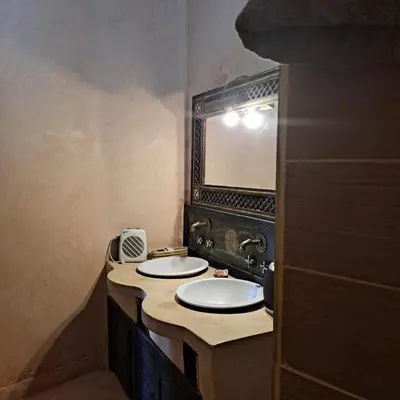 a bathroom with two sinks and a mirror at Riad Kasbah Omar in Ourika
