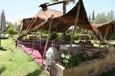 a tent with a table and chairs in a yard at VILLA CATHERINE MARRAKECH in Marrakech