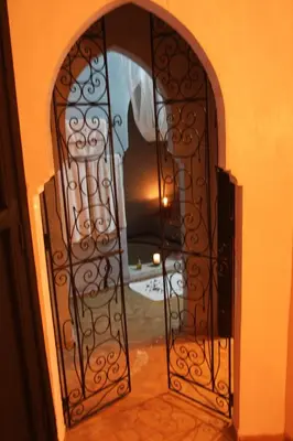 an entry door with a metal gate in a hallway at VILLA CATHERINE MARRAKECH in Marrakech