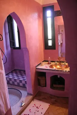 a purple bathroom with a sink and a shower at VILLA CATHERINE MARRAKECH in Marrakech