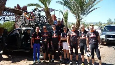 a group of people standing next to a truck with bikes on the back at Chez Kossai Atlas Farm in Chtawna