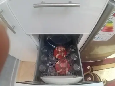 a container filled with wine bottles in a refrigerator at Ryan S1et Ryan S2 in Fès