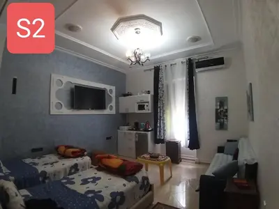 a small room with two beds and a tv at Ryan S1et Ryan S2 in Fès