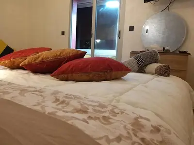 a bed with four pillows on top of it at Ryan S1et Ryan S2 in Fès