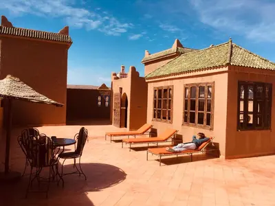 a man laying on a couch on a patio at Le Sauvage Noble in Tissergat