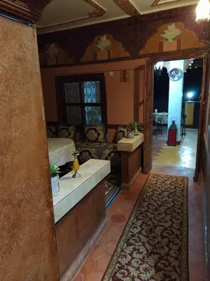 a living room with a bed and a couch at Kasbah La Famille Berbère in Boumalne