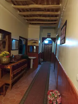 a hallway of a house with a couch and a table at Kasbah La Famille Berbère in Boumalne