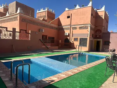 a swimming pool in the courtyard of a building at Kasbah La Famille Berbère in Boumalne