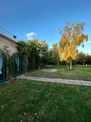 a park with a picnic table and a tree at Villa privée Wafa in Marrakech