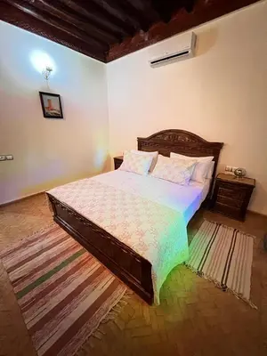 a bedroom with a large bed in a room at Villa privée Wafa in Marrakech