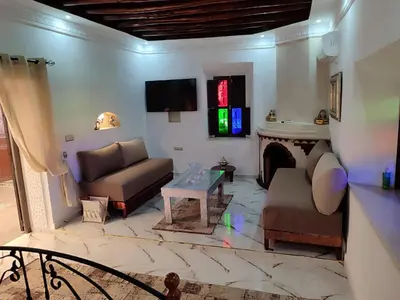a living room with a couch and a fireplace at Villa privée Wafa in Marrakech