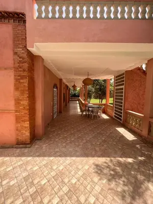 a patio with a table and chairs on a building at Villa privée Wafa in Marrakech