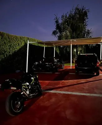 a motorcycle parked under a tent in a parking lot at Villa privée Wafa in Marrakech