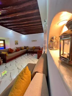 a living room with a couch and a table at Villa privée Wafa in Marrakech