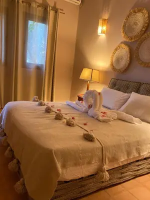 a bedroom with a bed with a stuffed animal on it at Upupa de l’Atlas in Marrakech