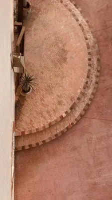 an overhead view of a circular ramp with a plant at Upupa de l’Atlas in Marrakech