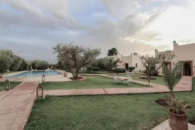a yard with a swimming pool and a house at Upupa de l’Atlas in Marrakech
