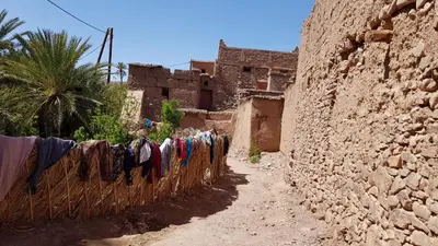 an alley with clothes drying on a fence at ecolodge bivouac des aigles in Ouarzazate