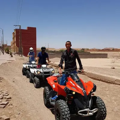 three men on atvs on a dirt road at ecolodge bivouac des aigles in Ouarzazate