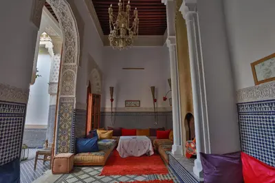a living room with a couch and a chandelier at RIAD LOUDAYA AND SPA in Fès