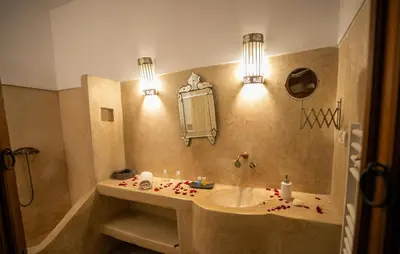 a bathroom with a sink and a mirror at RIAD LOUDAYA AND SPA in Fès