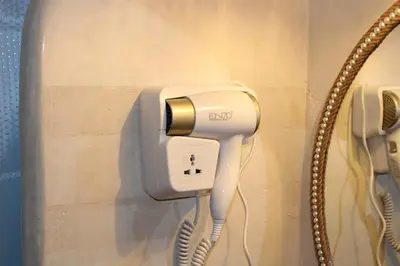 a hair dryer plugged into a phone in a bathroom at Dar Mezyana Dades in Aït Idaïr